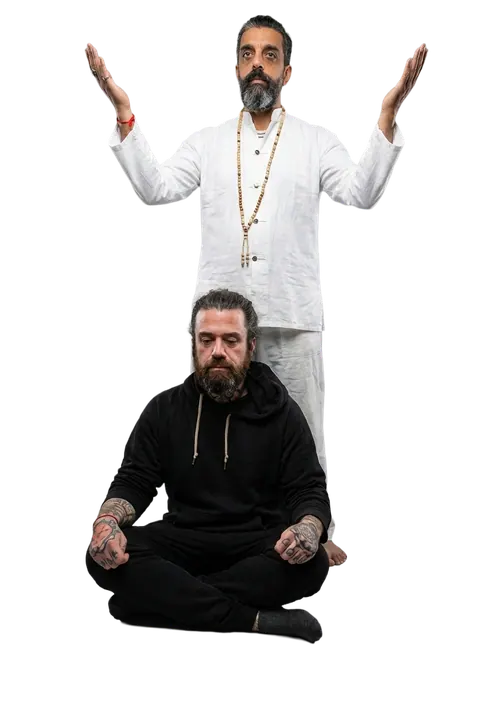 Ali Taghavi in white robes with arms raised in blessing, and seated in meditation